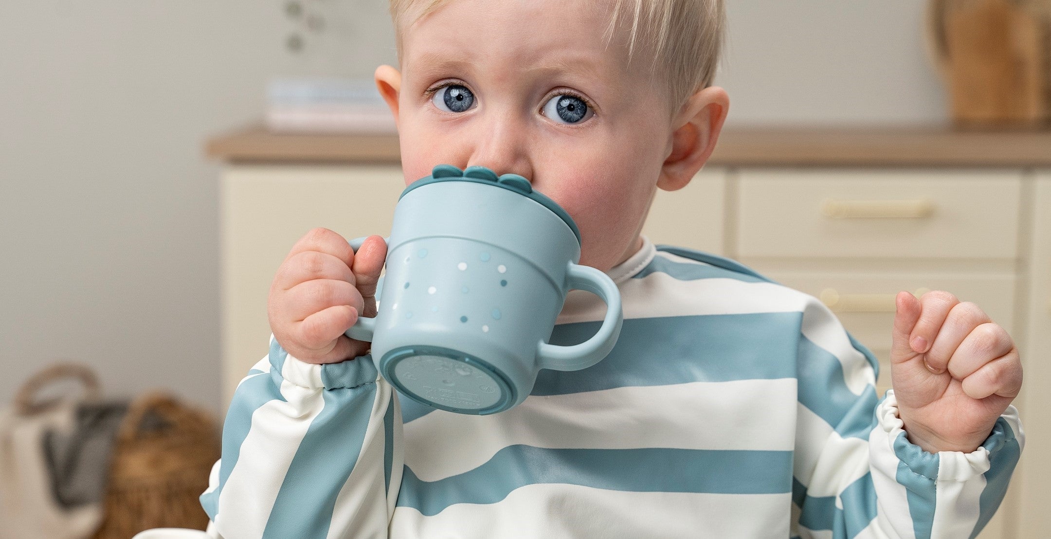 Boy driking from a blue Done by Deer spout and snack cup