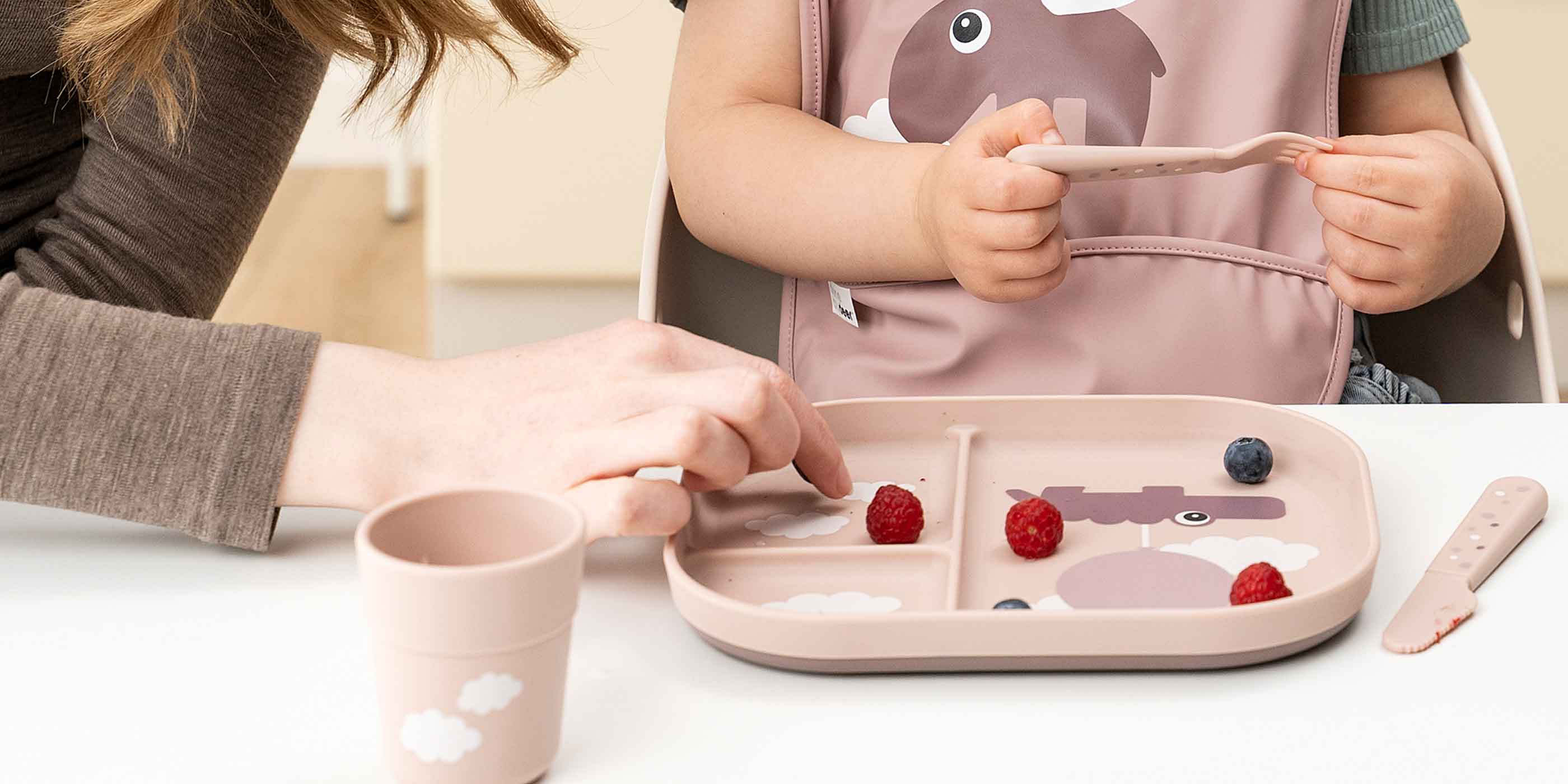 Girl and mother at dinner time with powder Done by Deer Foodie tableware