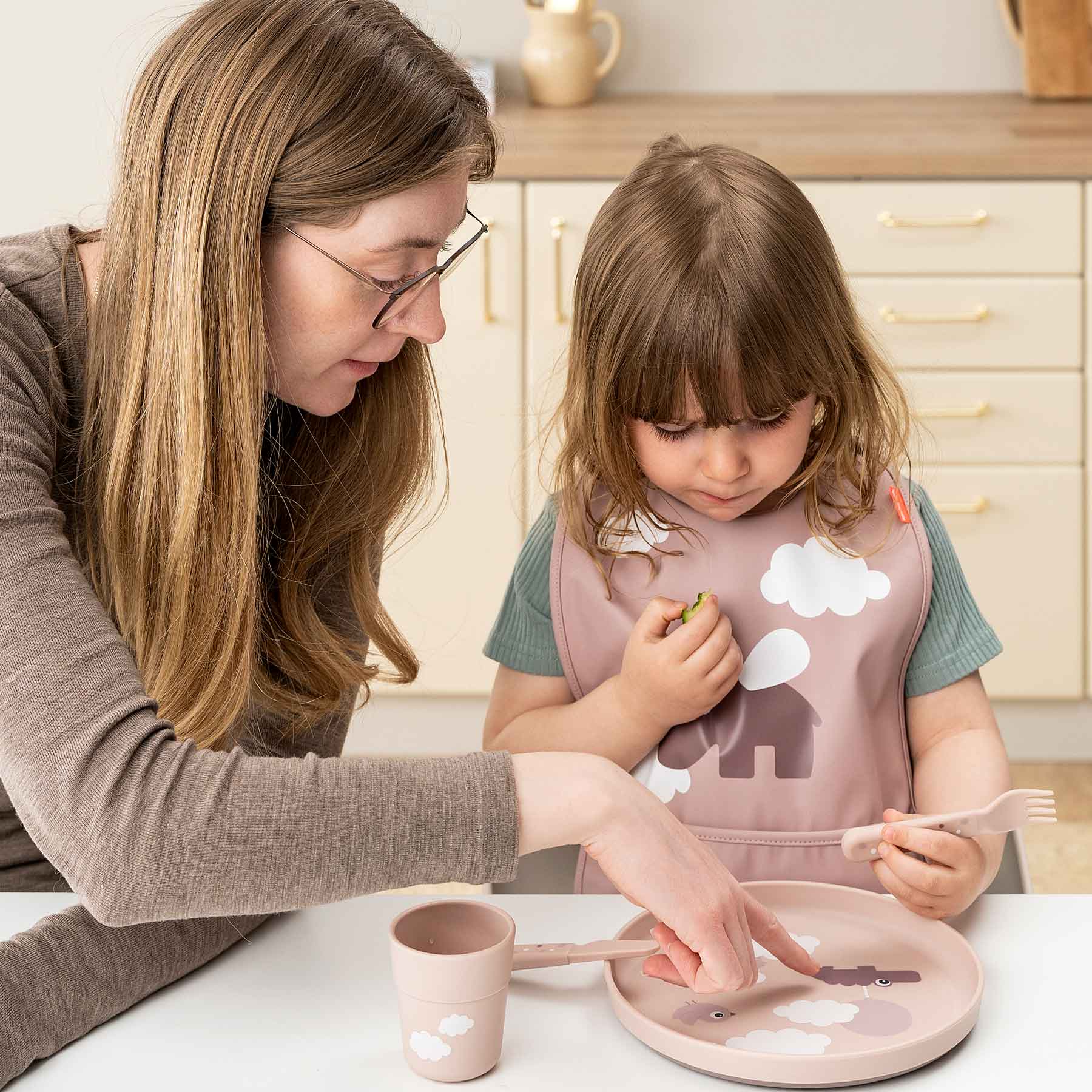 Girl and mother at dinner time with powder Done by Deer Foodie tableware