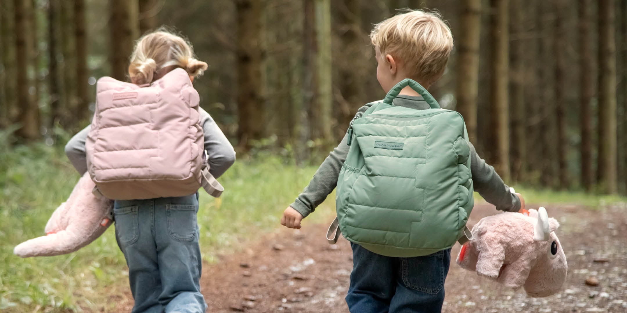 two children with Done by Deer quilted kids backpacks