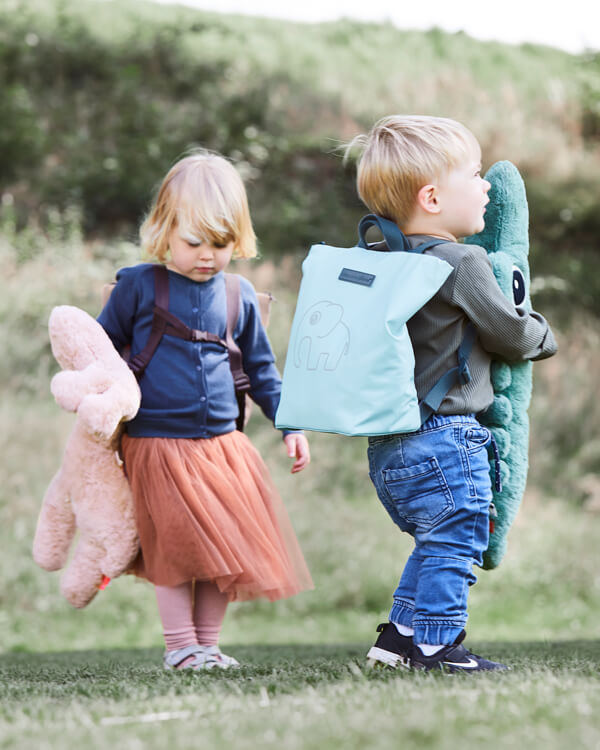 Boy and girl with cool kids bags in recycled polyester in blue and powder from Done by Deer with Elhpee elephant