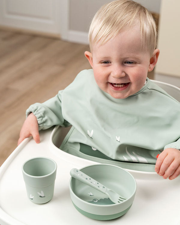 Child learning to eat by its own using Done by Deer dinnerware