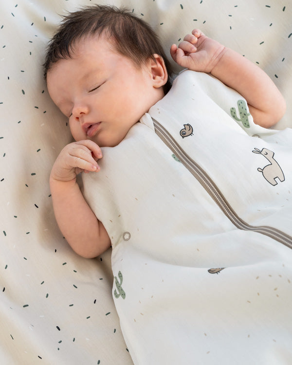 Newborn sleeping in a Done by Deer baby sleeping bag