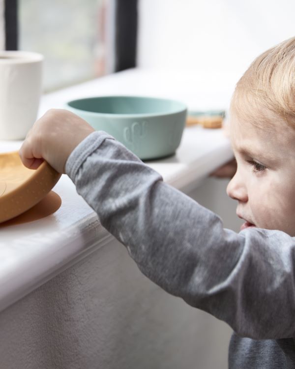 Stick and stay silicone tableware from Done by Deer in mustard, green and powder