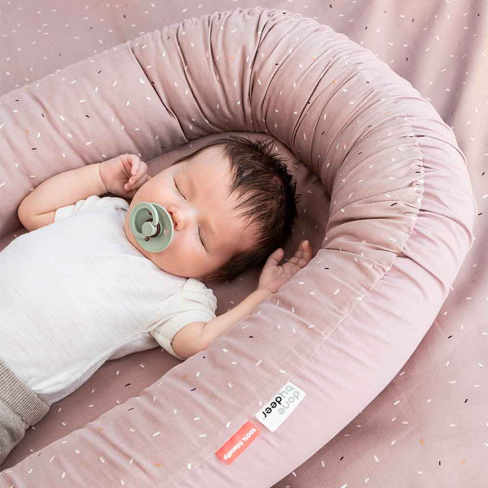 Baby sleeping in a cozy baby nest