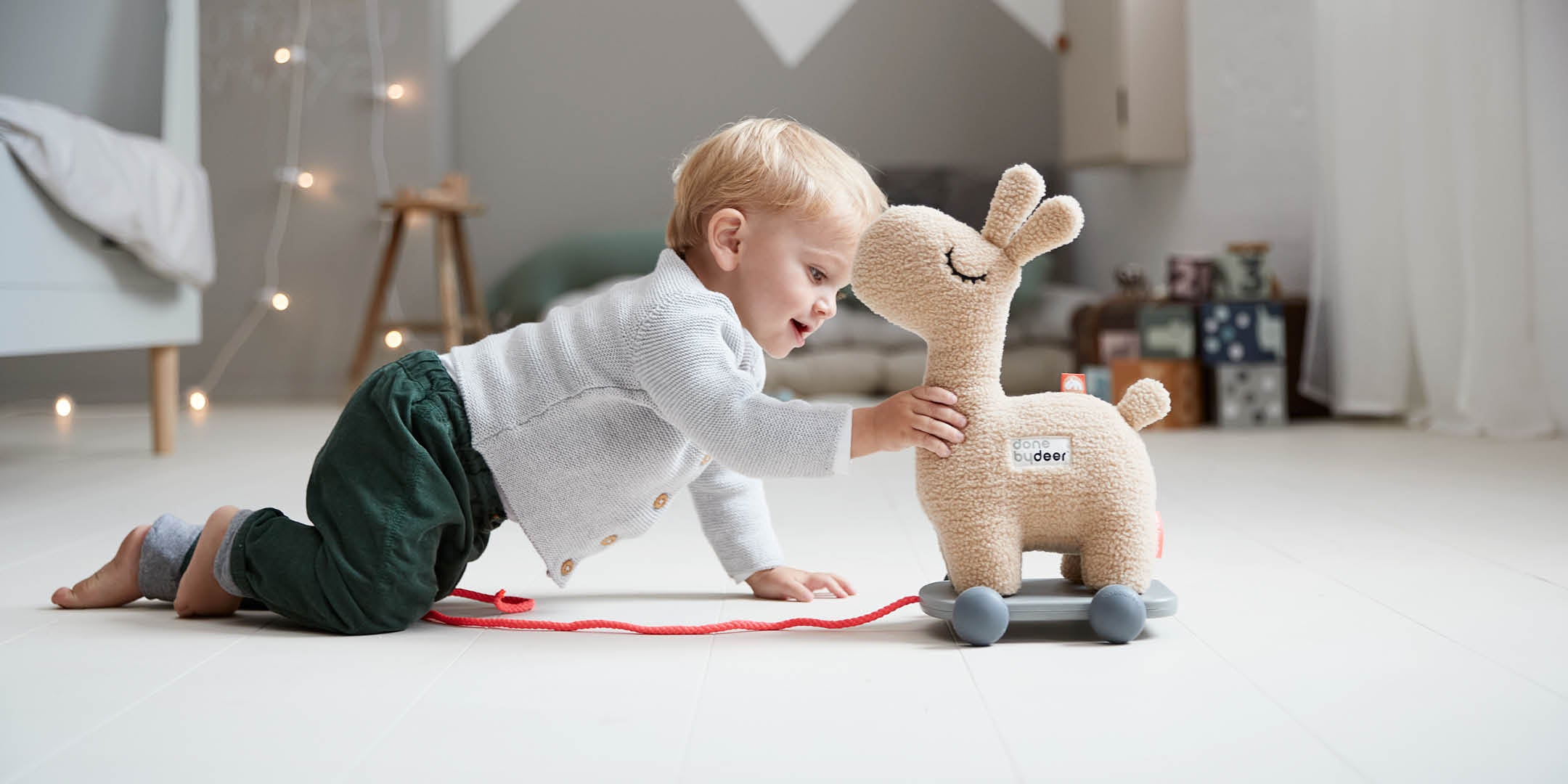 Boy playing with the Done by Deer Lalee pull-along toy